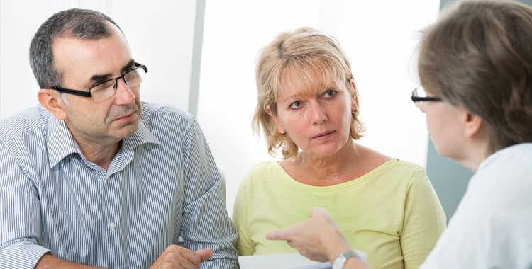 Retired couple talking to an adviser